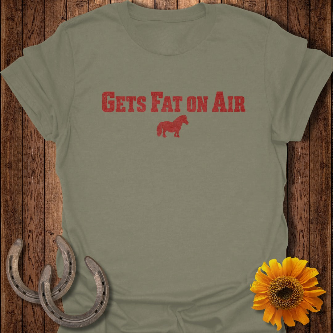 Olive t-shirt with red text "GETS FAT ON AIR" and a small horse graphic.