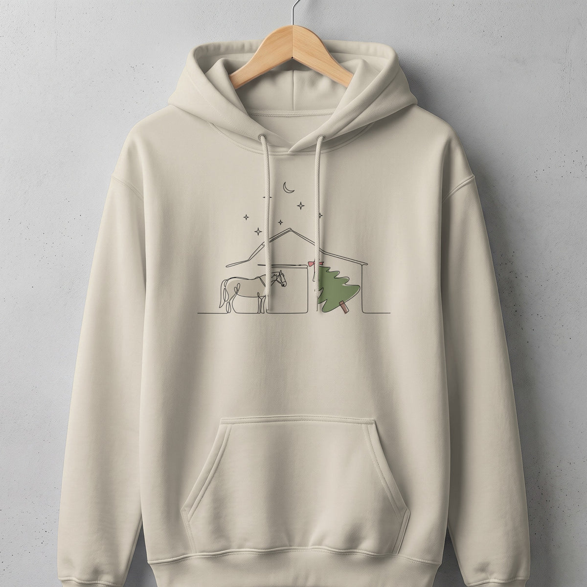 Beige hoodie with a minimalist line drawing of a horse and a Christmas tree.