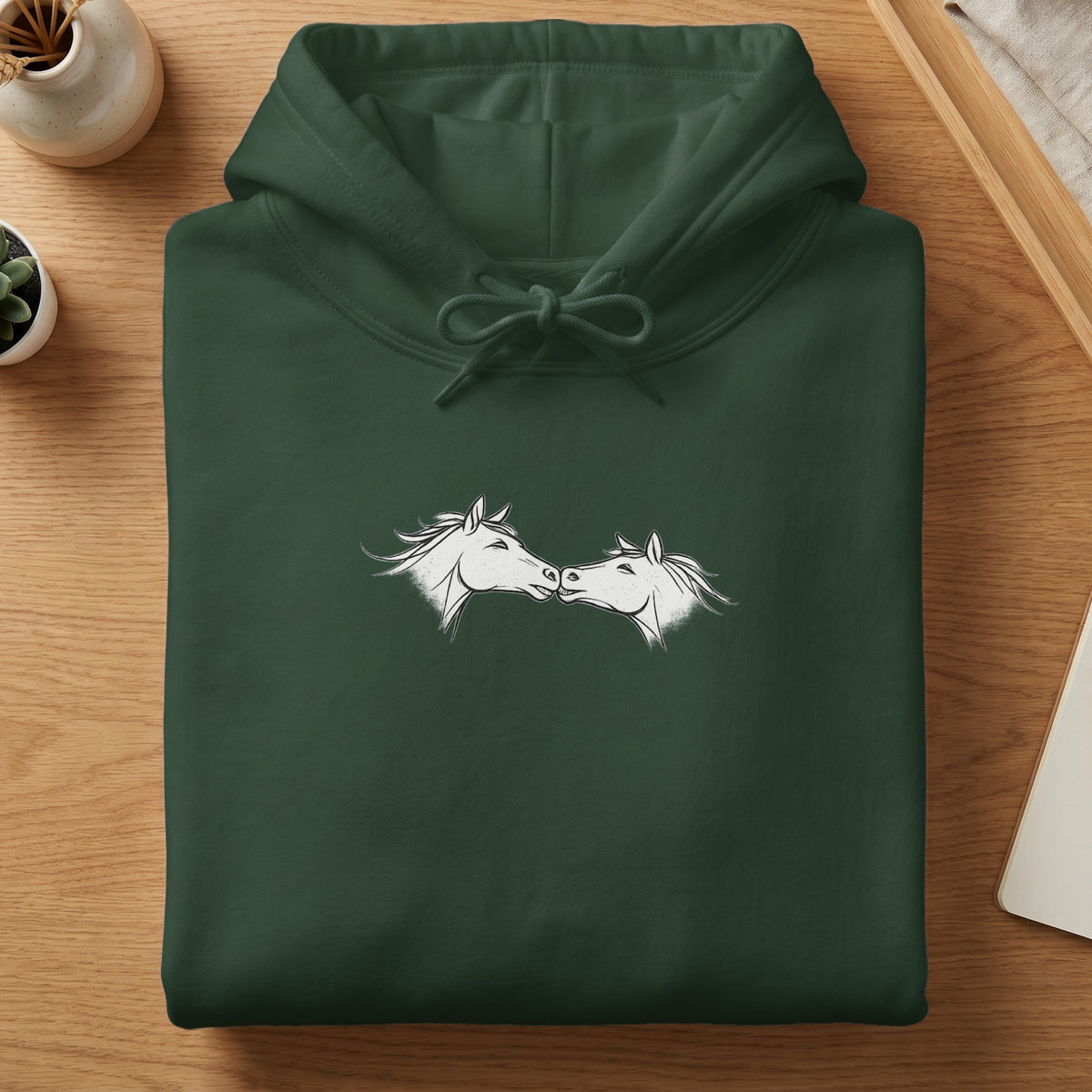 Dark green hoodie with white sketch of two horses facing each other.