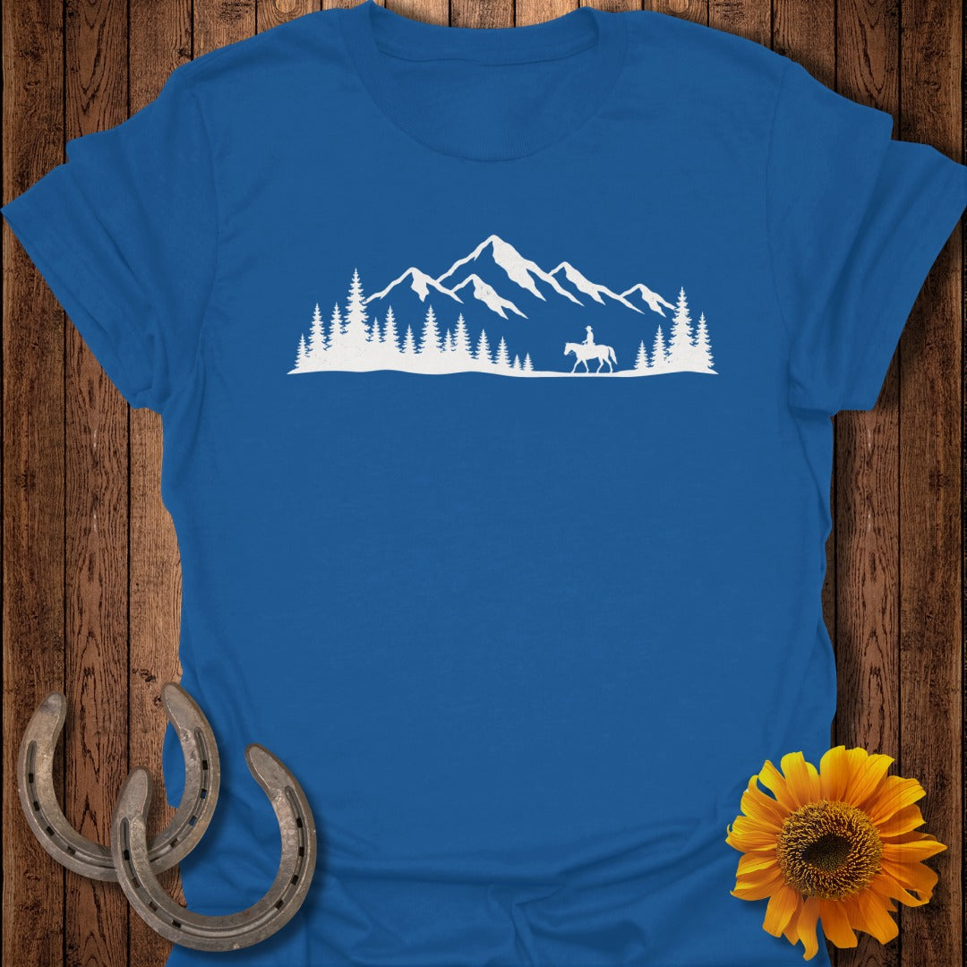 Blue t-shirt with white mountain and horse rider graphic.