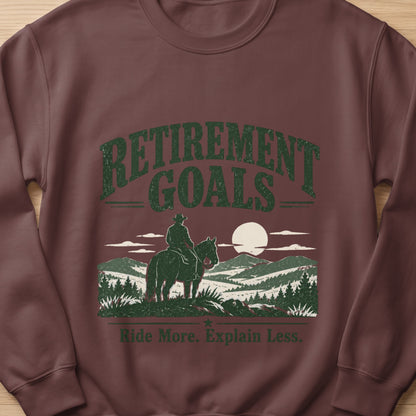 Brown sweatshirt with "Retirement Goals" and a cowboy on horseback.