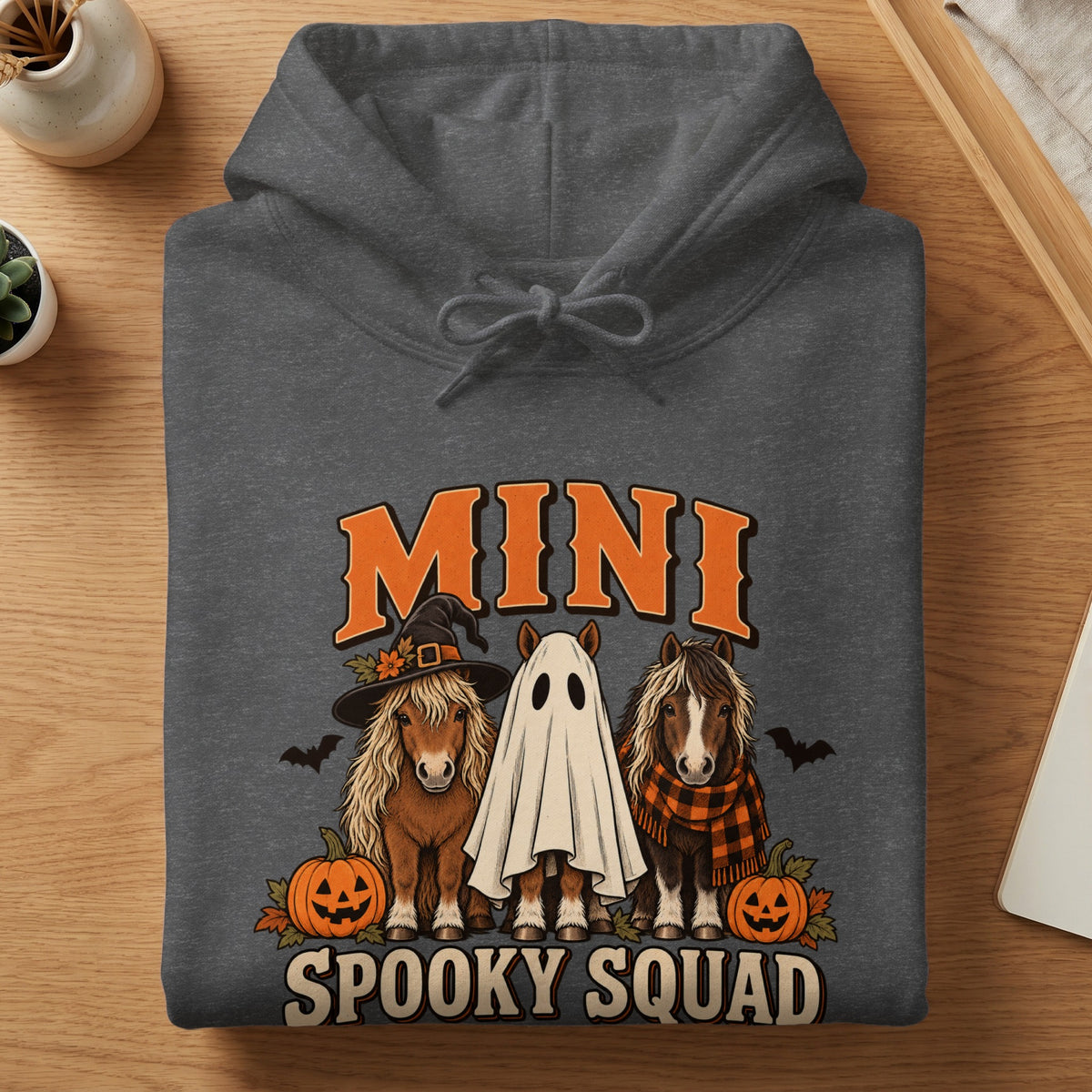 Dark gray hoodie with "MINI SPOOKY SQUAD" text featuring three ponies in Halloween costumes.