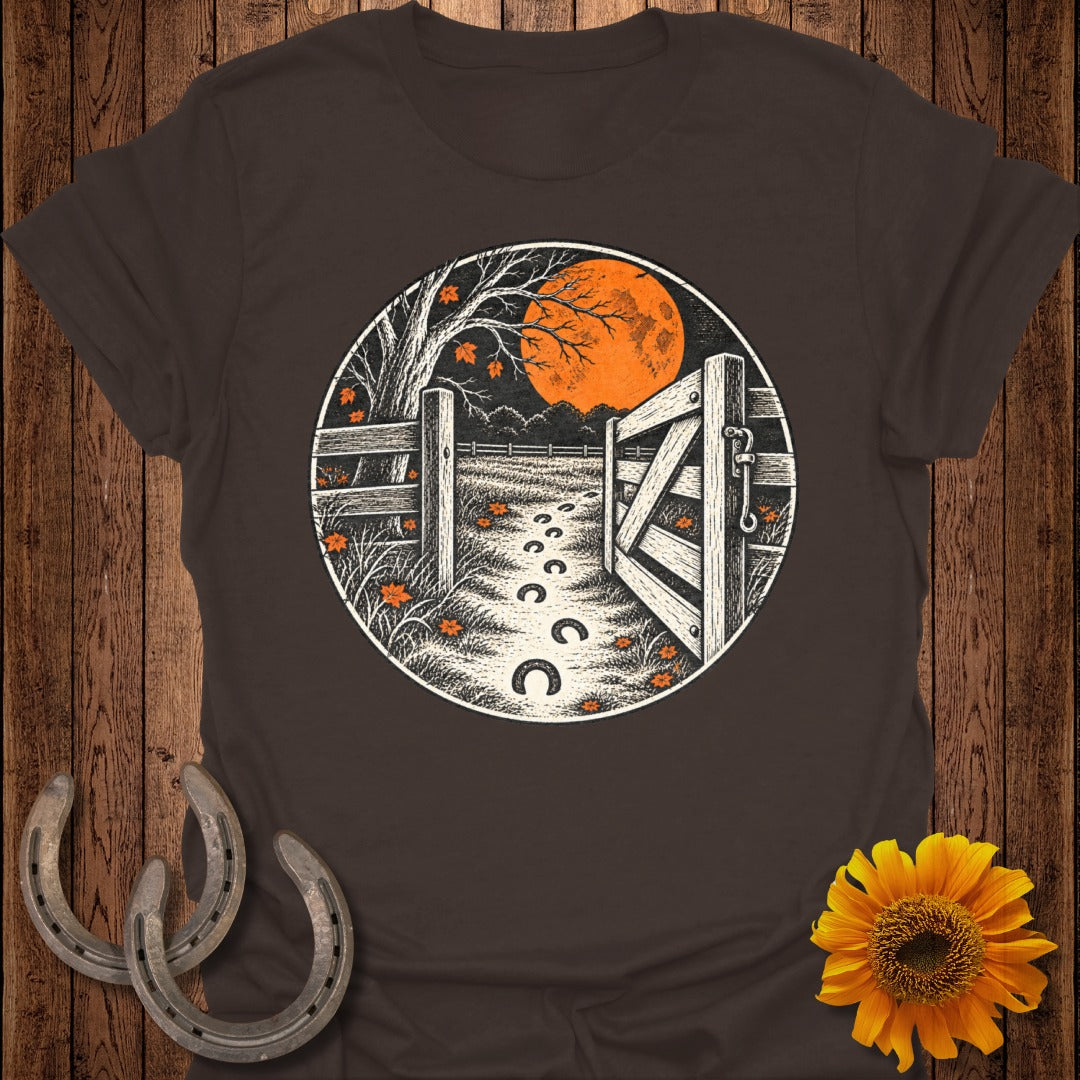 Farm scene with open gate, moon, and horseshoe footprints on shirt.