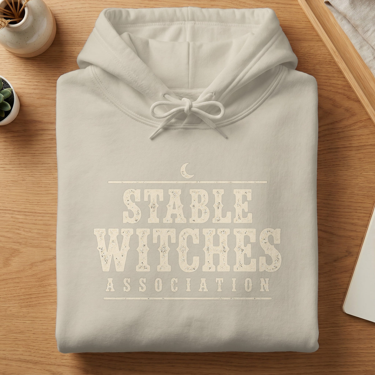 Light grey hoodie with distressed text: Stable Witches Association.