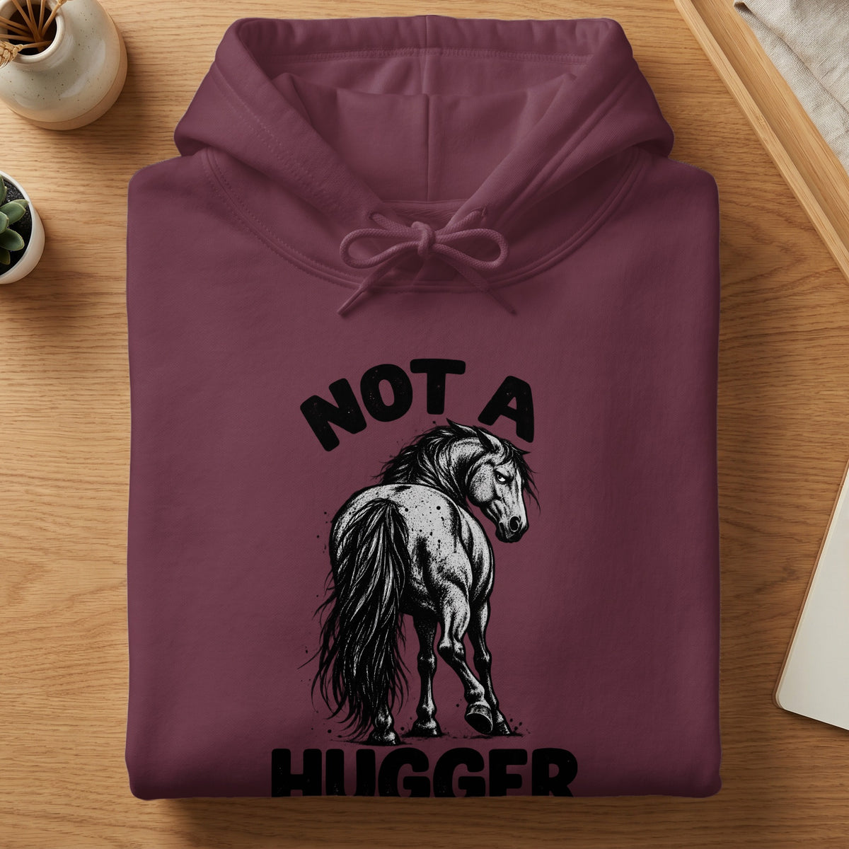 Maroon hoodie with a black graphic of a horse and text "NOT A HUGGER".