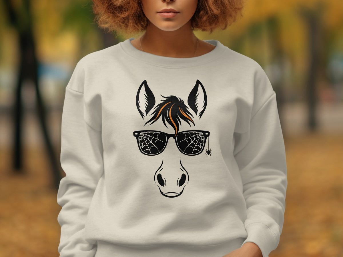 Horse face with spiderweb sunglasses and a small spider on a white sweatshirt.