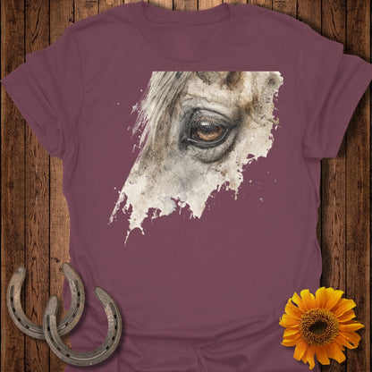 Burgundy t-shirt featuring a close-up watercolor painting of a horse's eye.