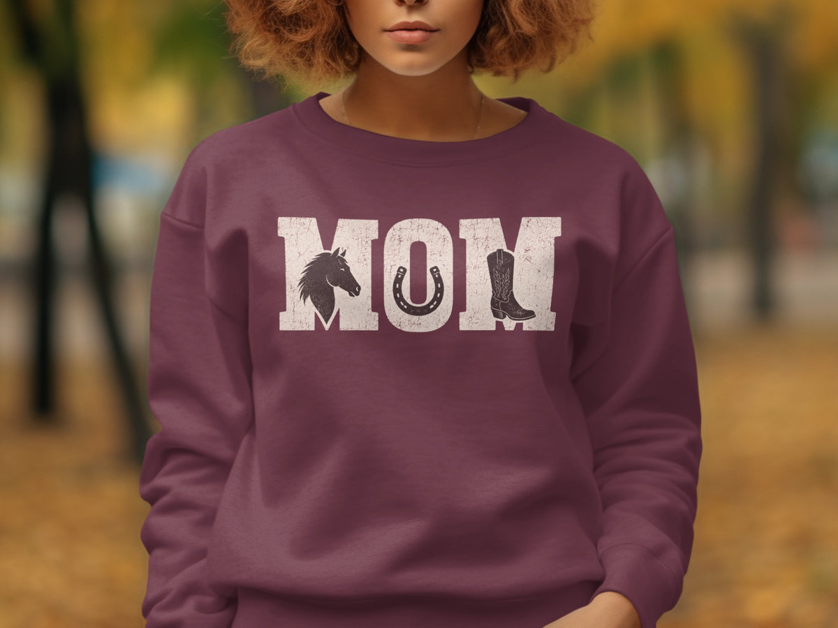Crewneck sweatshirt with "MOM" text, horse, horseshoe, and boot graphic.