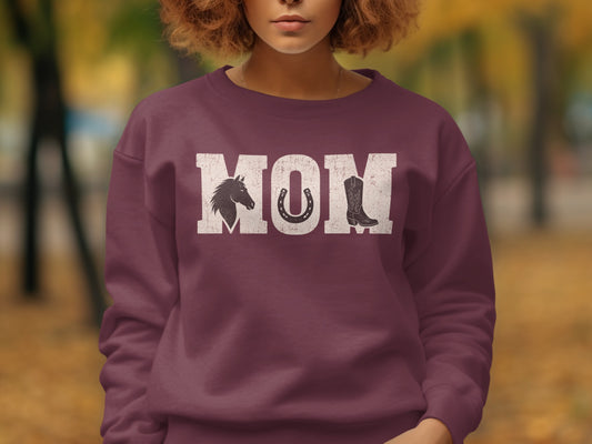 Crewneck sweatshirt with "MOM" text, horse, horseshoe, and boot graphic.