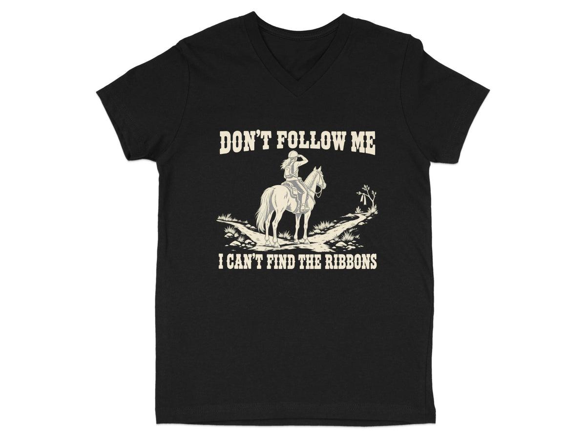 A black V-neck t-shirt featuring cream-colored text reading "DON'T FOLLOW ME I CAN'T FIND THE RIBBONS" and a graphic of a horse and rider.