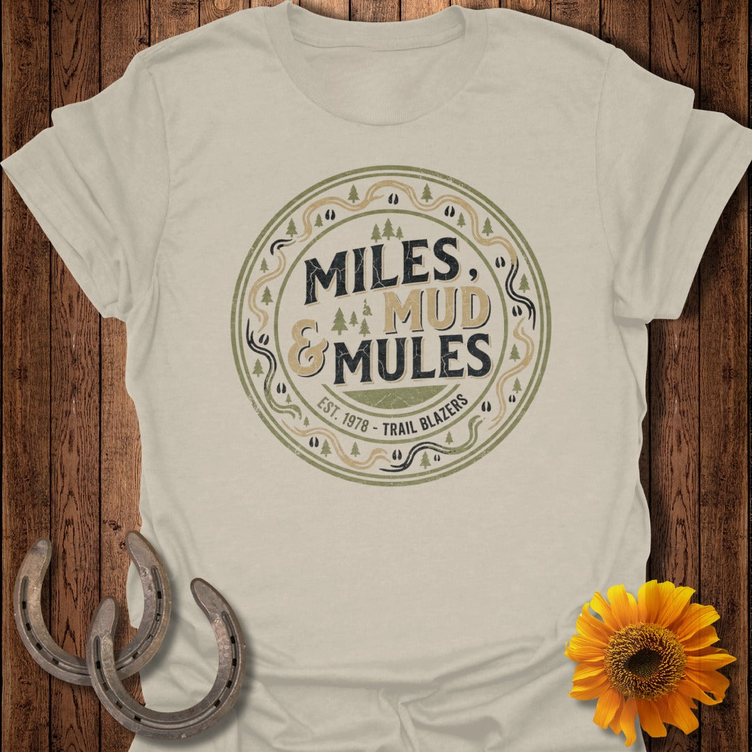 Cream t-shirt with "Miles & Mud Trail Blazers" circular logo.