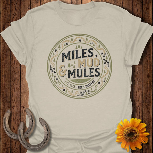 Cream t-shirt with "Miles & Mud Trail Blazers" circular logo.