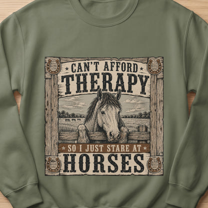 Green sweatshirt with horses, fence, and text: "Can't afford therapy so I just stare at horses."