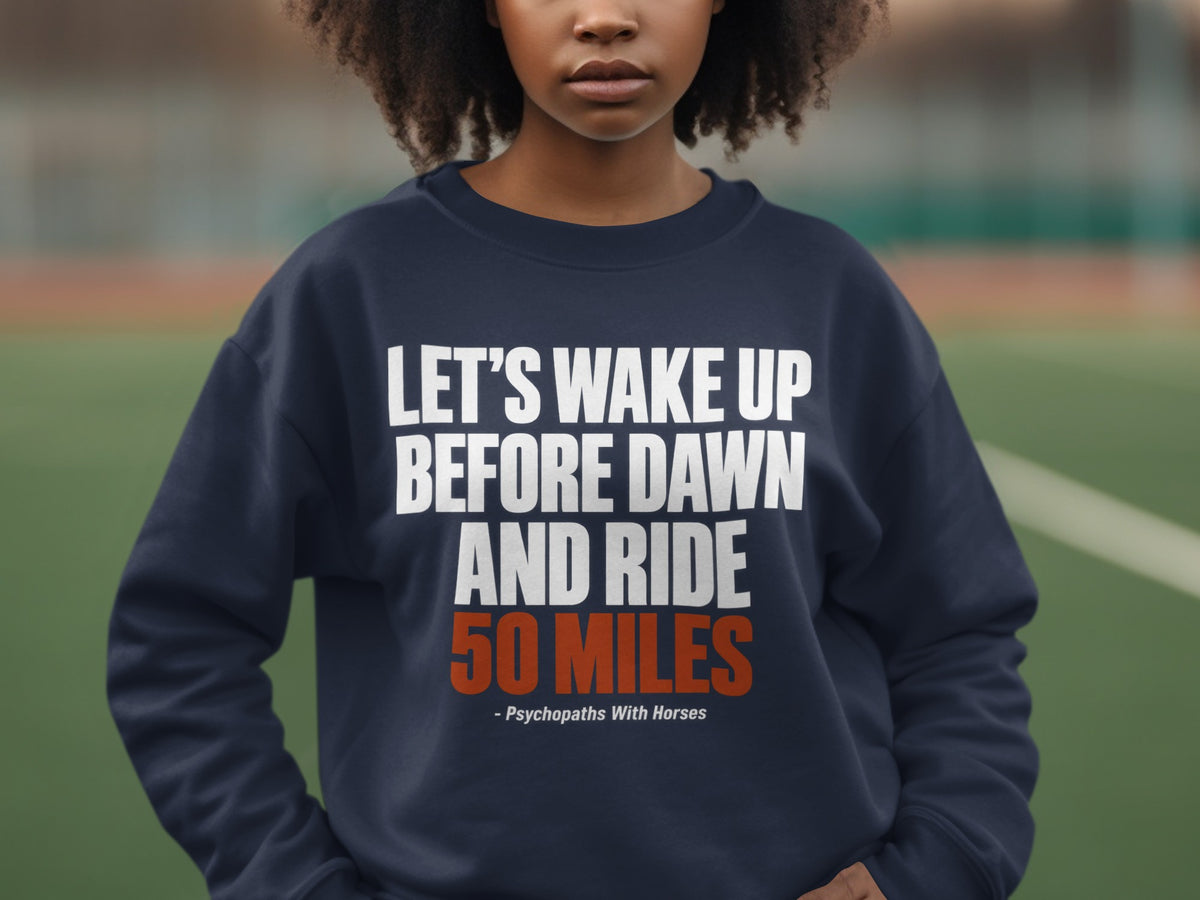 A person wearing a dark blue crewneck sweatshirt with white and orange text.