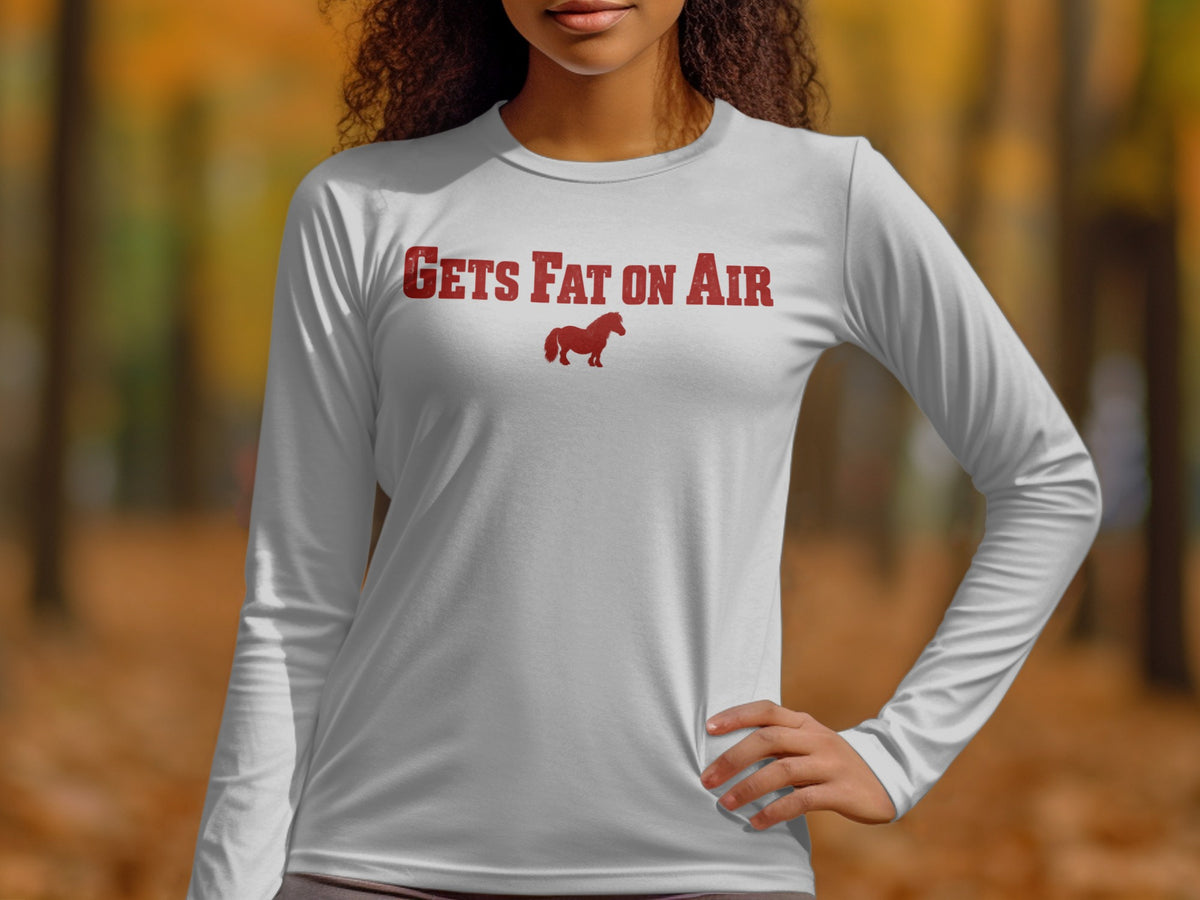 White long sleeve shirt with red text "GETS FAT ON AIR" and a horse graphic.