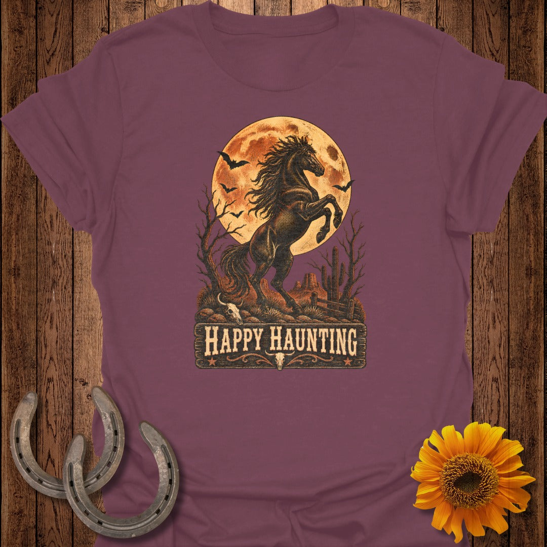 Rearing horse against a full moon with bats and desert landscape, "Happy Haunting" text.