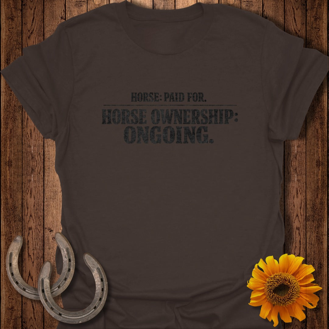 Brown t-shirt with text "HORSE: PAID FOR. HORSE OWNERSHIP: ONGOING."