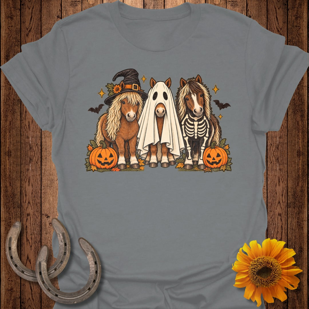 Three ponies dressed for Halloween with pumpkins, bats, and stars.