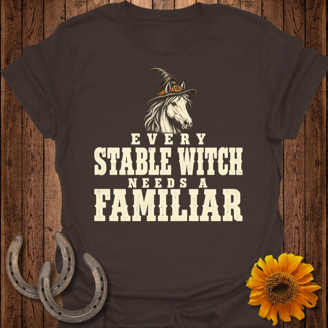 Brown t-shirt with "Every Stable Witch Needs a Familiar" text and a horse wearing a witch hat.