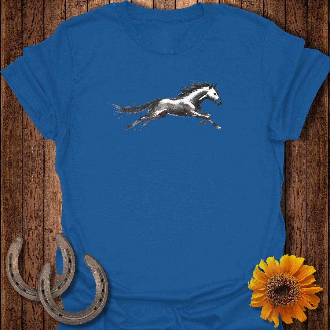Blue t-shirt with a dynamic watercolor-style black and white horse in mid-gallop.