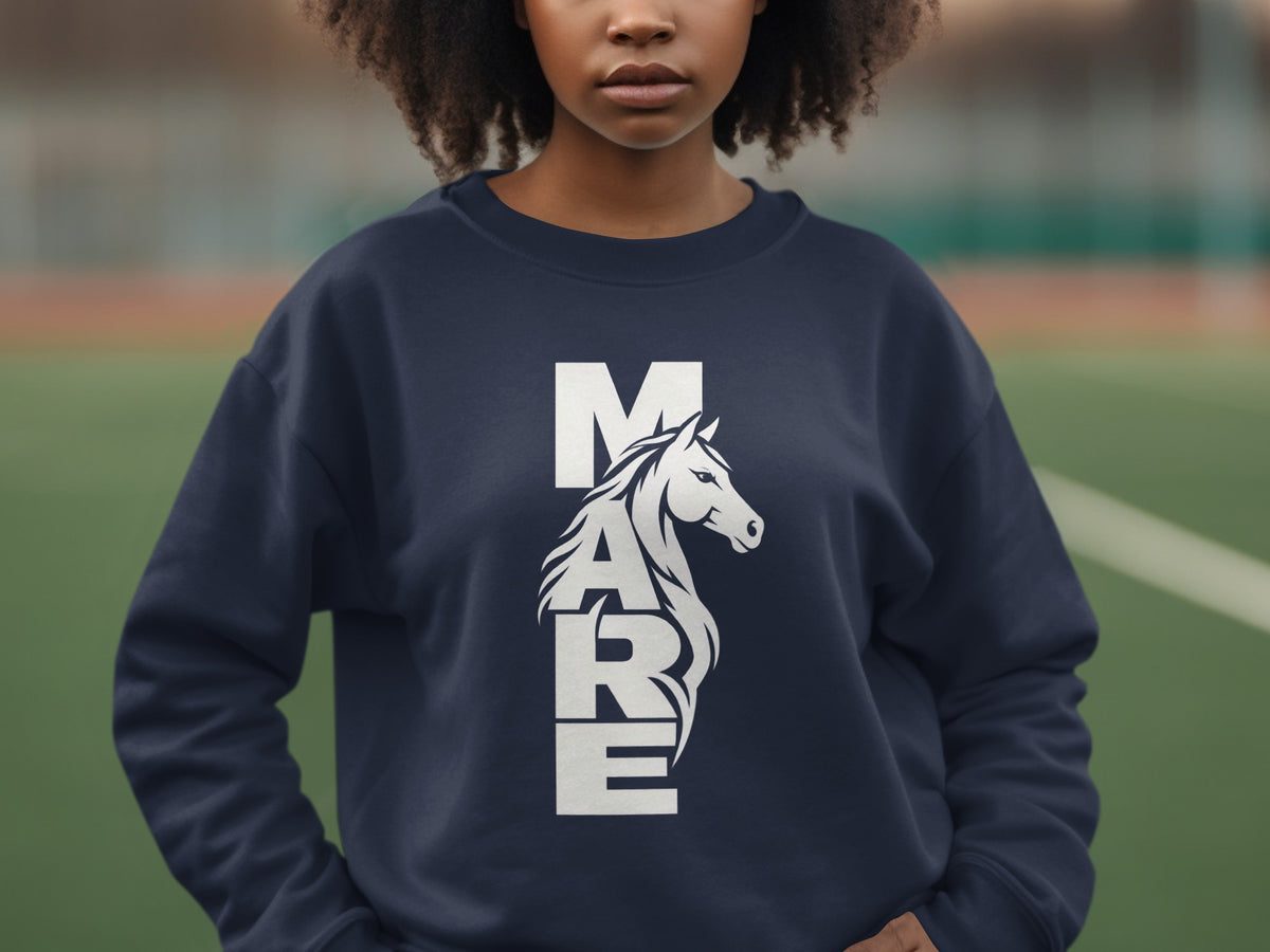 A person wearing a dark blue crewneck sweatshirt printed with the word MARE and a horse graphic.