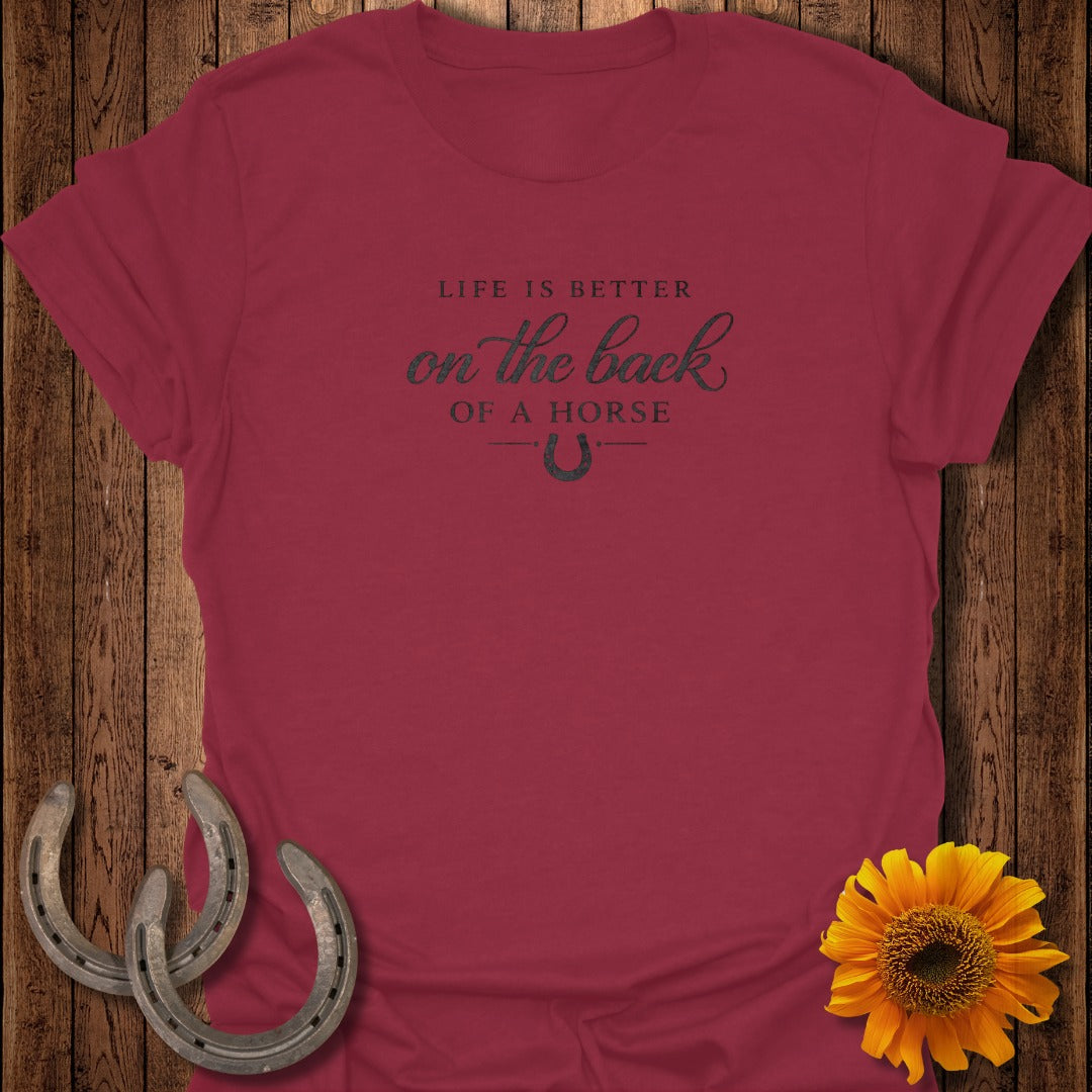 Maroon t-shirt with "Life is better on the back of a horse" text and horseshoe.