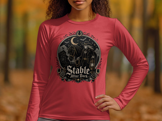 Red long-sleeve shirt featuring a "Stable After Dark" graphic with skeleton cowboy, horse, and barn.