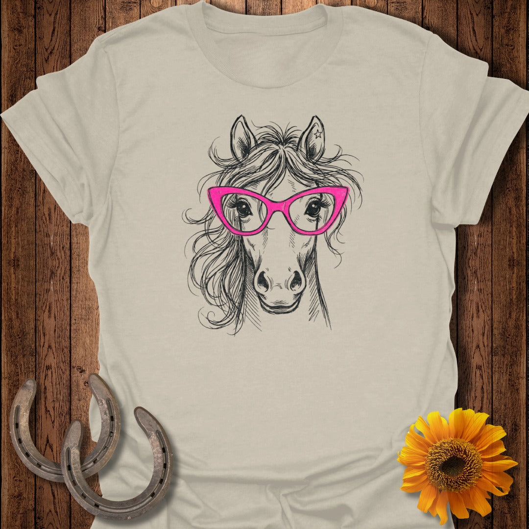 Sketch of a horse wearing pink glasses on a light t-shirt.
