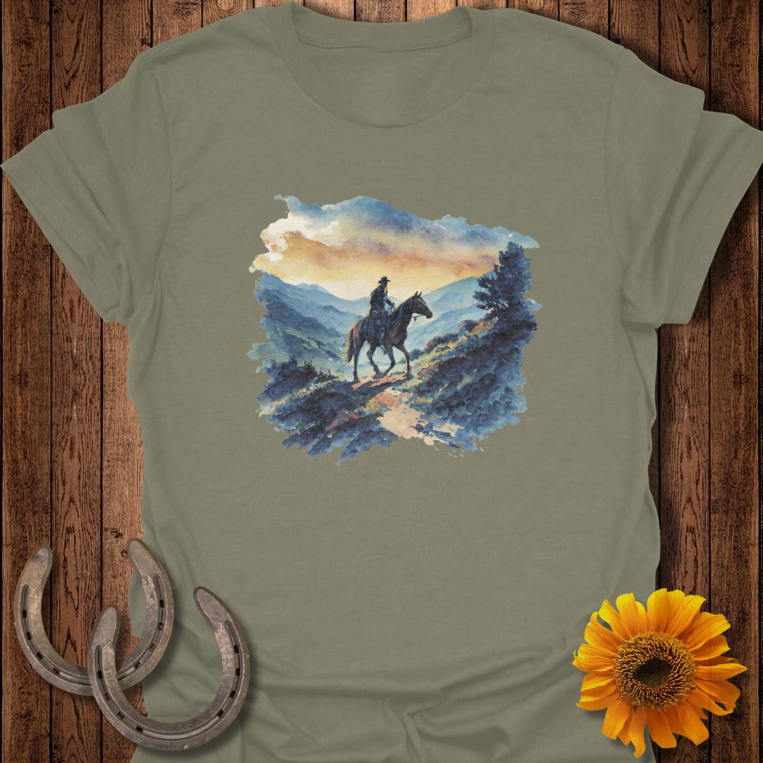 Watercolor painting of a cowboy on horseback on a mountain trail.