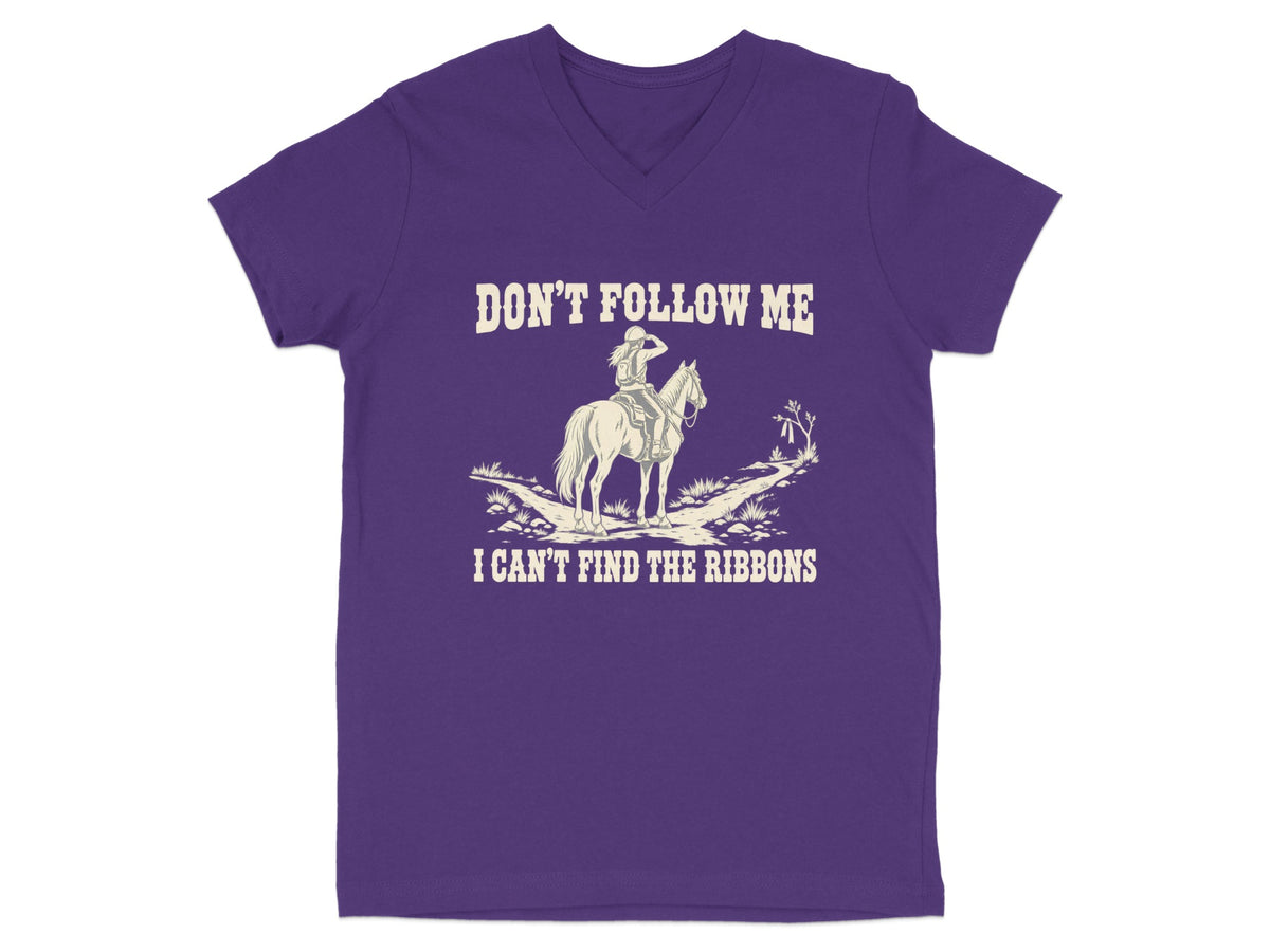 A purple V-neck t-shirt featuring cream-colored text that reads DON’T FOLLOW ME I CAN’T FIND THE RIBBONS and an illustration of a rider on a horse.
