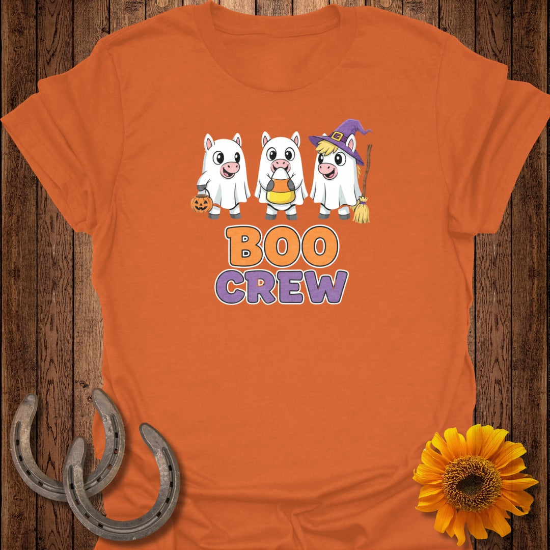 Three cartoon pigs in ghost costumes with text "BOO CREW" on an orange t-shirt.