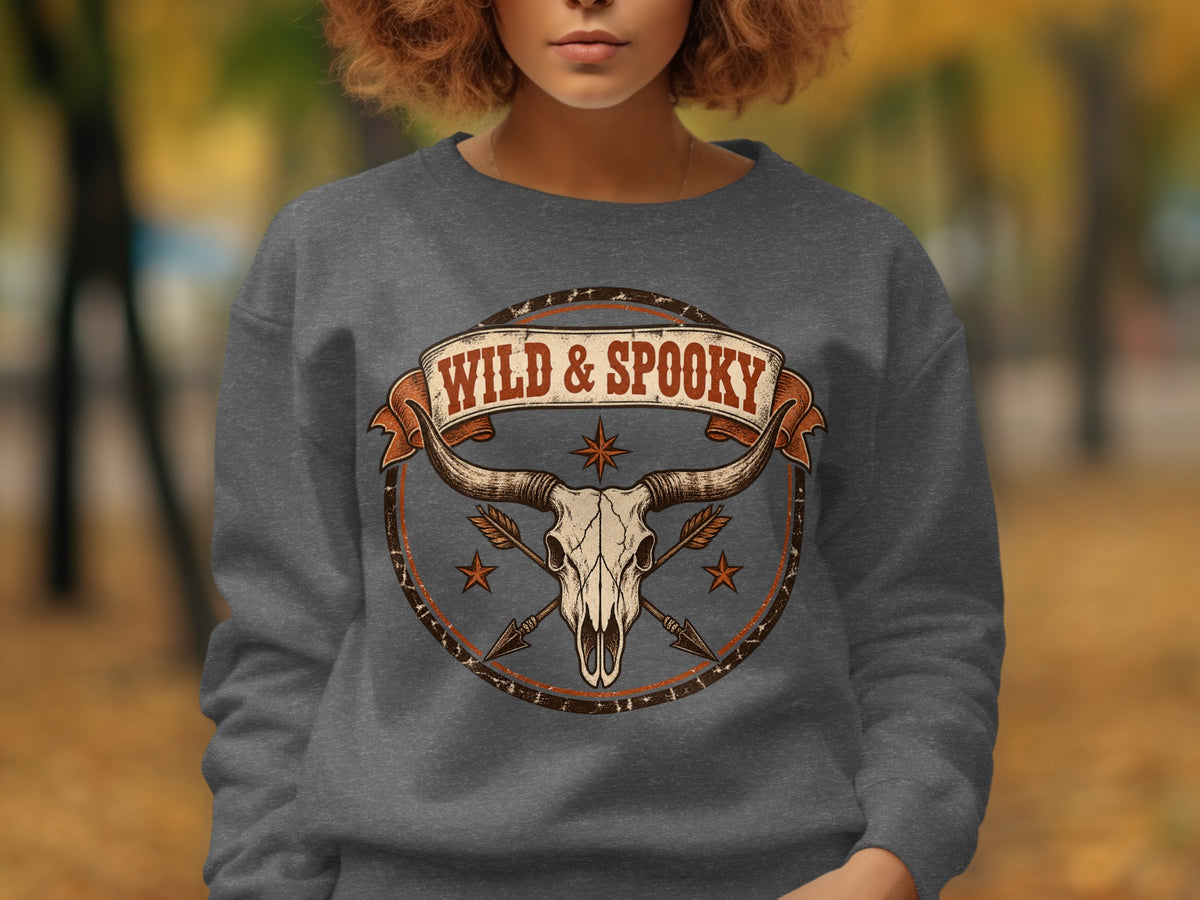 Longhorn skull with arrows and "Wild & Spooky" text on a grey sweatshirt.