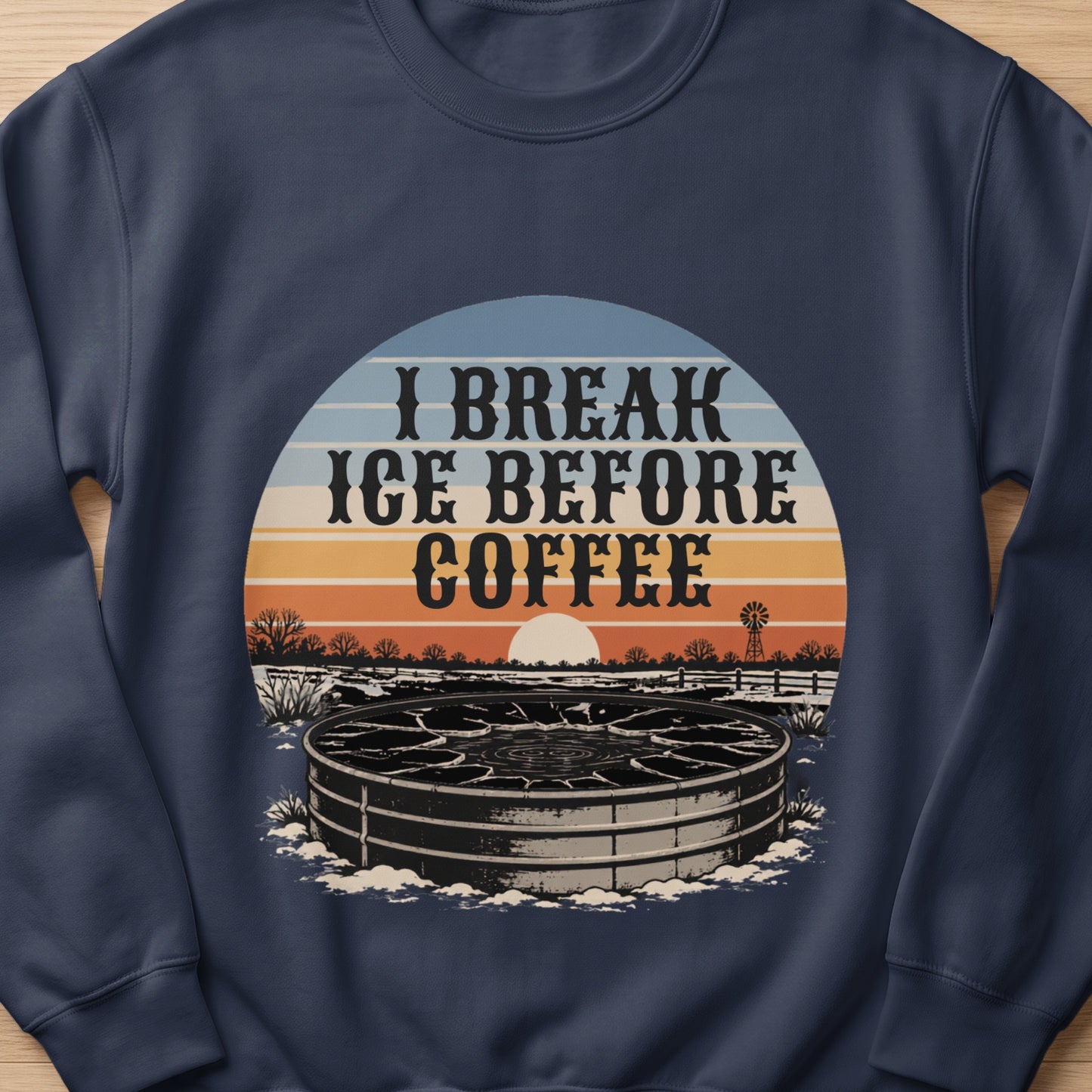 Dark blue sweatshirt with a circular graphic featuring "I BREAK ICE BEFORE COFFEE" and a rural scene.
