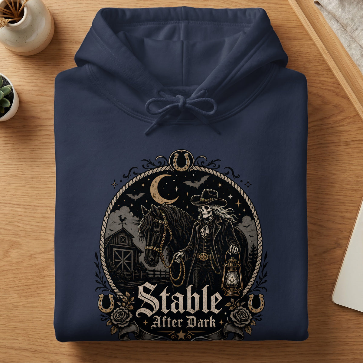 Navy hoodie with "Stable After Dark" graphic featuring a skeleton cowboy and horse.
