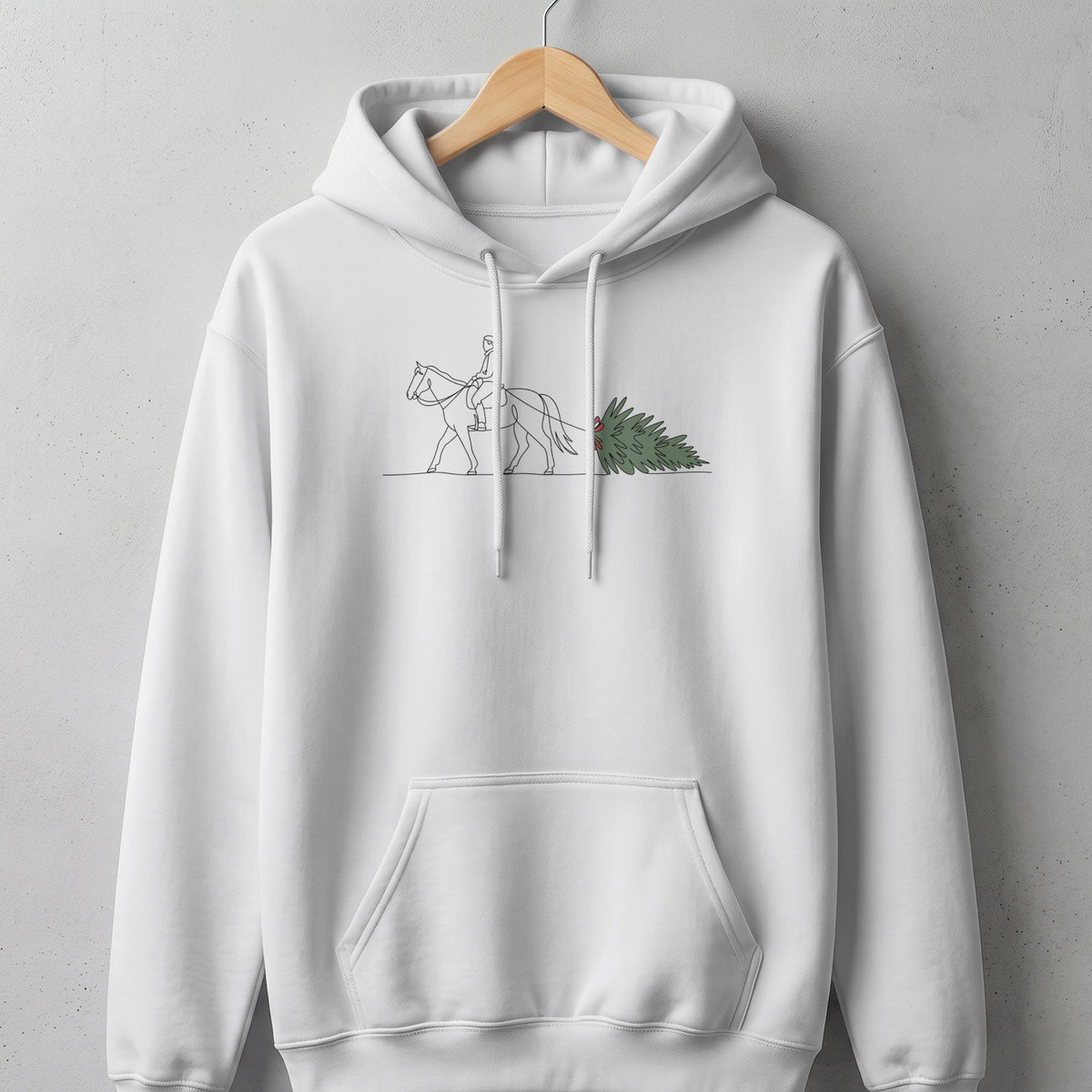 White hoodie with a minimalist line drawing of a person riding a horse pulling a Christmas tree.