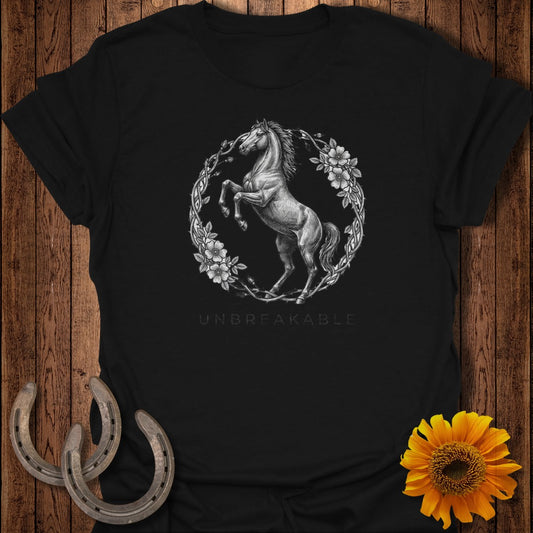 Black t-shirt with a rearing horse and floral wreath graphic, "UNBREAKABLE" text below.
