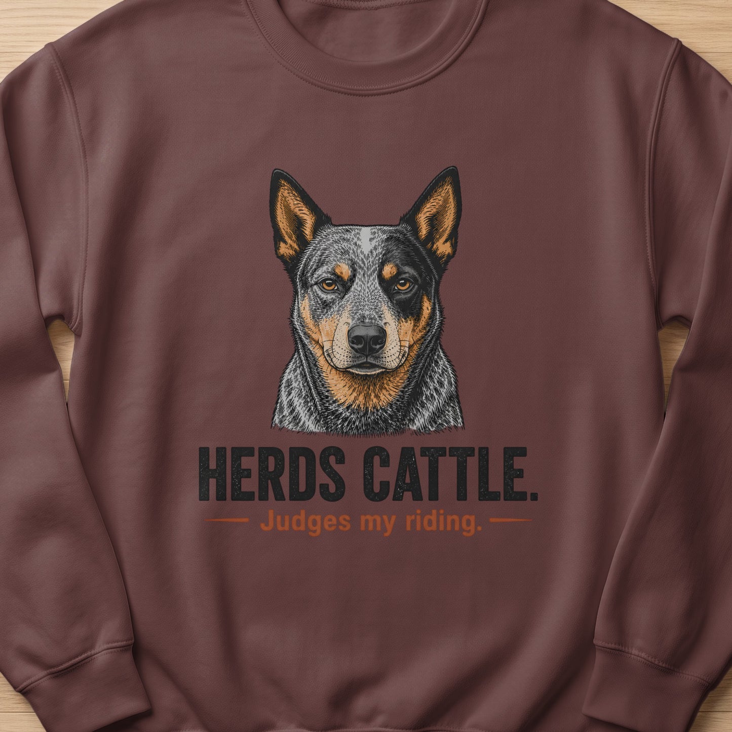 Brown sweatshirt with a detailed illustration of an Australian Cattle Dog and text.