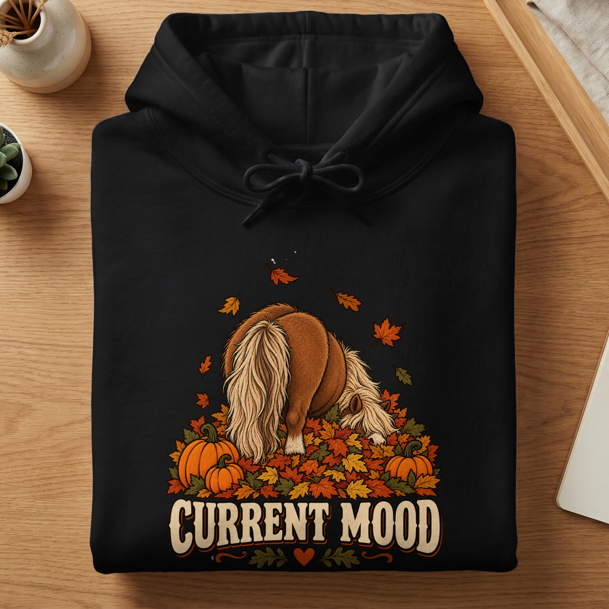 Black hoodie with a graphic of a horse in fall leaves and pumpkins, reads "Current Mood".
