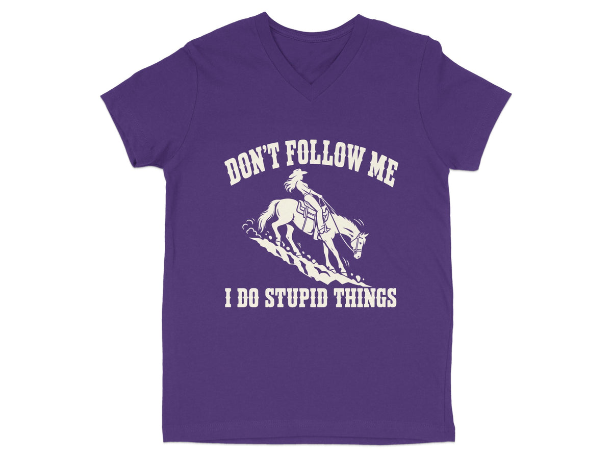 A purple V-neck t-shirt featuring a white graphic of a cowgirl riding a horse with text reading DON'T FOLLOW ME I DO STUPID THINGS.