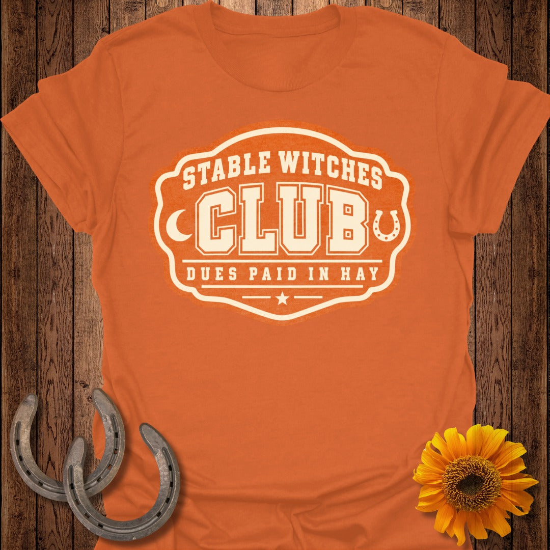 Orange t-shirt with "Stable Witches Club" and "Dues Paid In Hay" text.