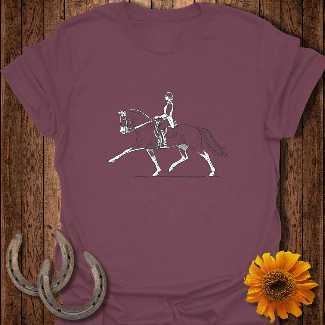 Line drawing of a dressage rider and horse on a maroon t-shirt.