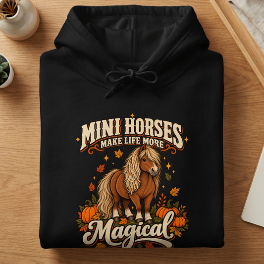 Black hoodie with "Mini Horses Make Life More Magical" text and autumn horse graphic.