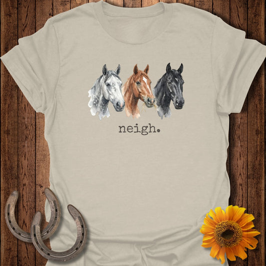 Three watercolor horse heads with "neigh." text on a tan t-shirt.