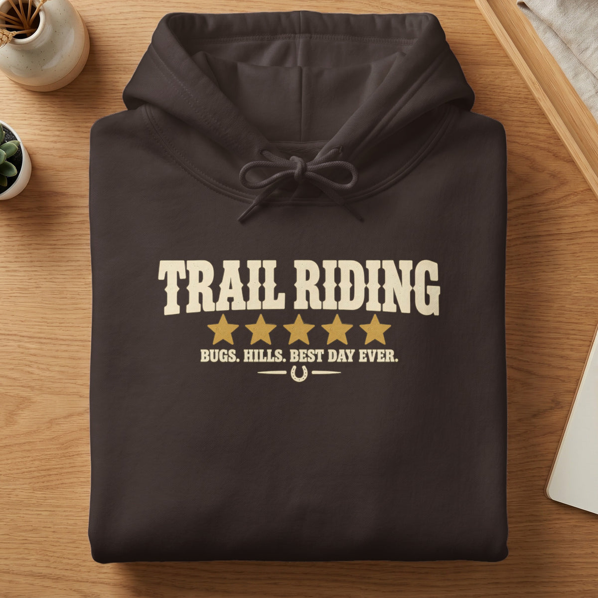 Dark brown hoodie with "TRAIL RIDING" and "BUGS. HILLS. BEST DAY EVER." text.