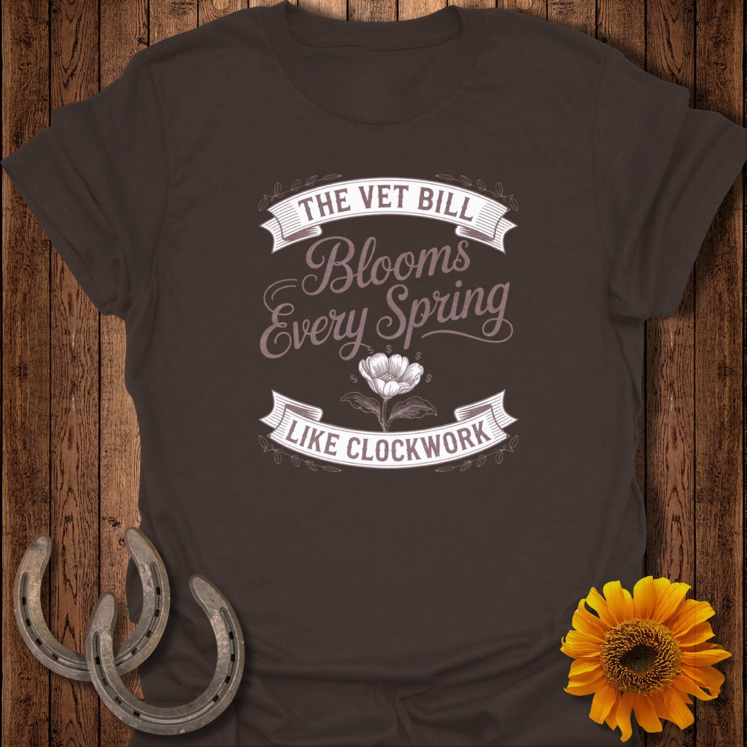 Brown t-shirt with "The Vet Bill Blooms Every Spring Like Clockwork" and flower graphic.