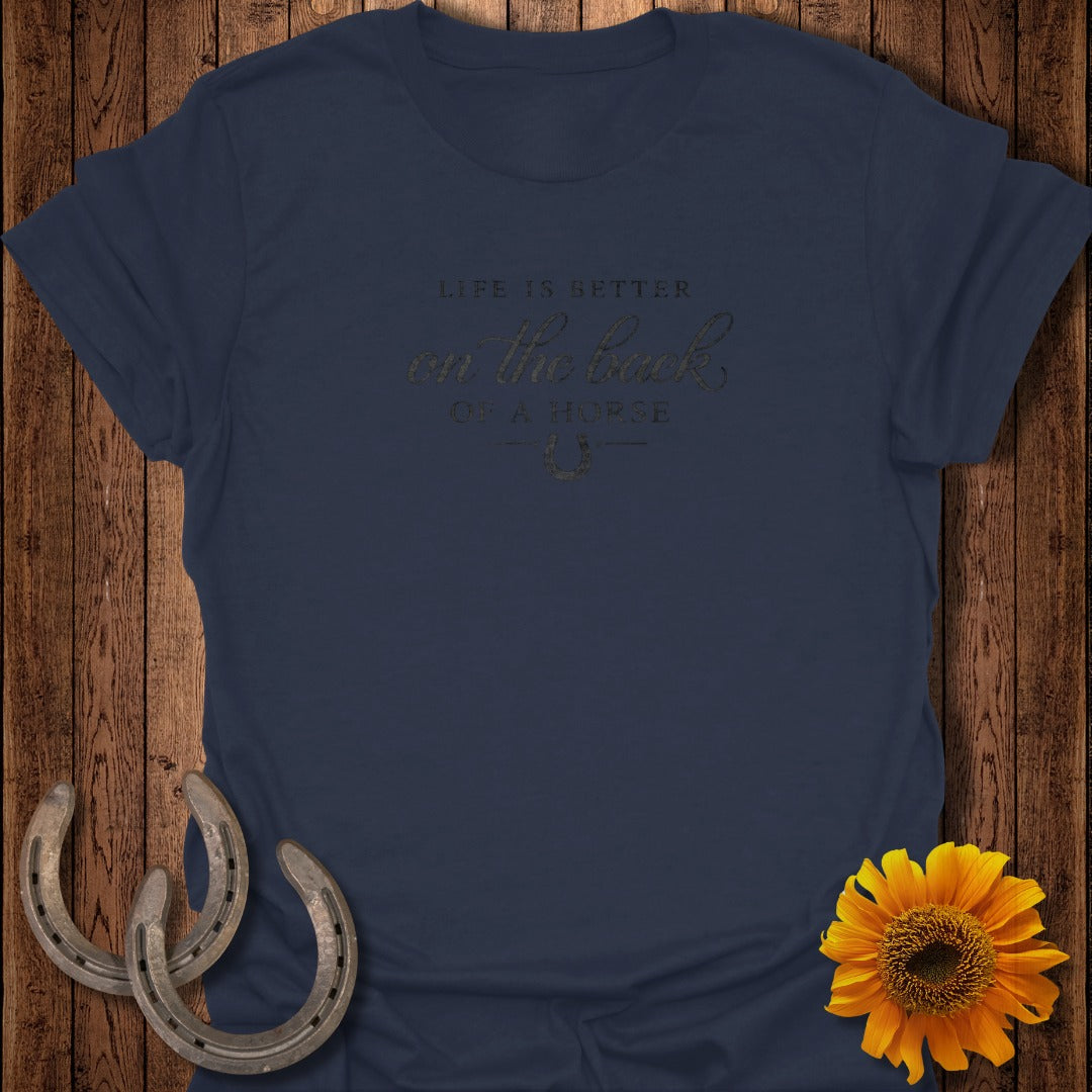 Navy t-shirt with "Life is better on the back of a horse" text and horseshoe graphic.