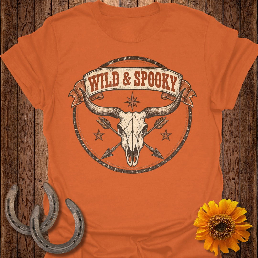 Orange t-shirt with "Wild & Spooky" text above a steer skull with arrows.