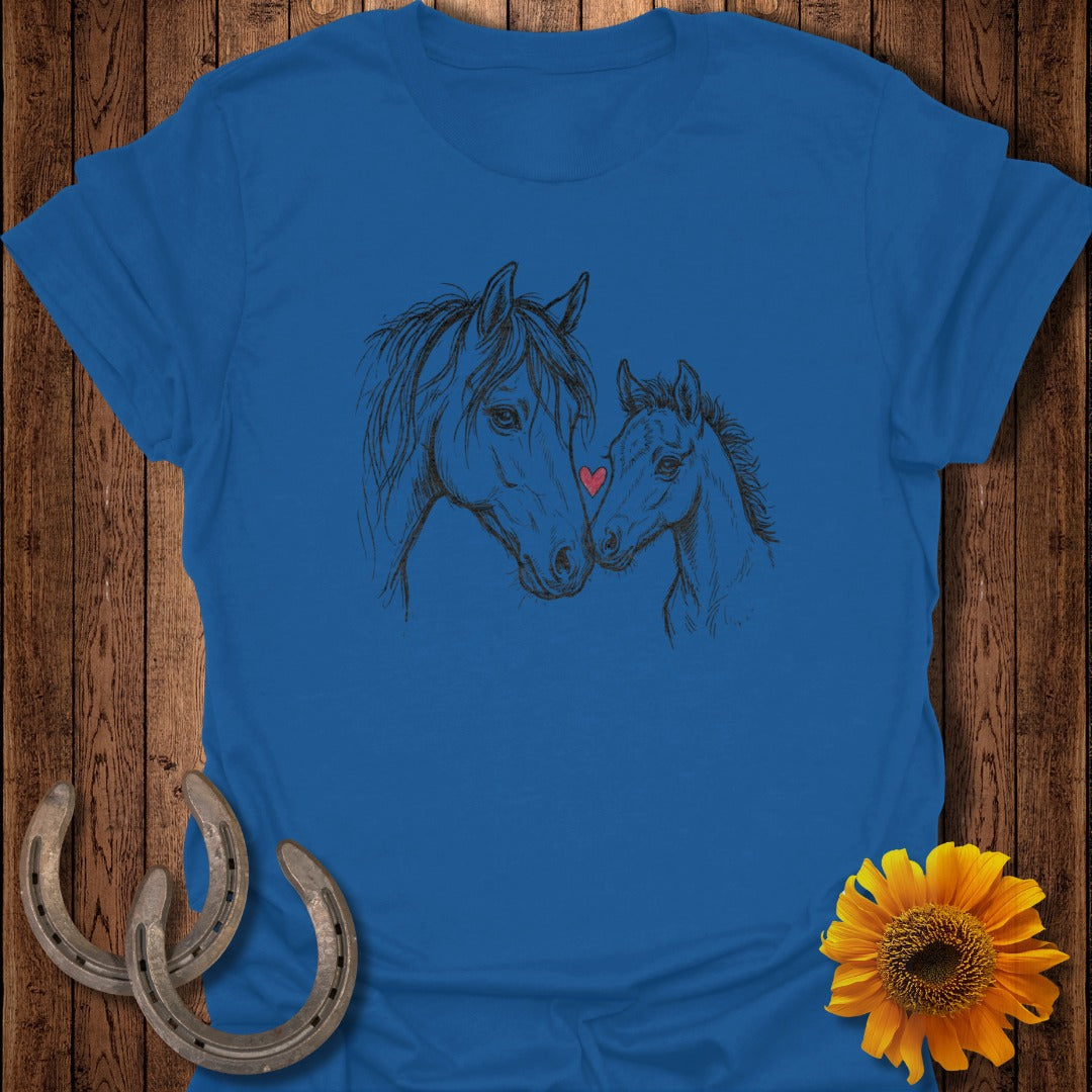Two horses, a mare and foal, with a small red heart, on a blue t-shirt.