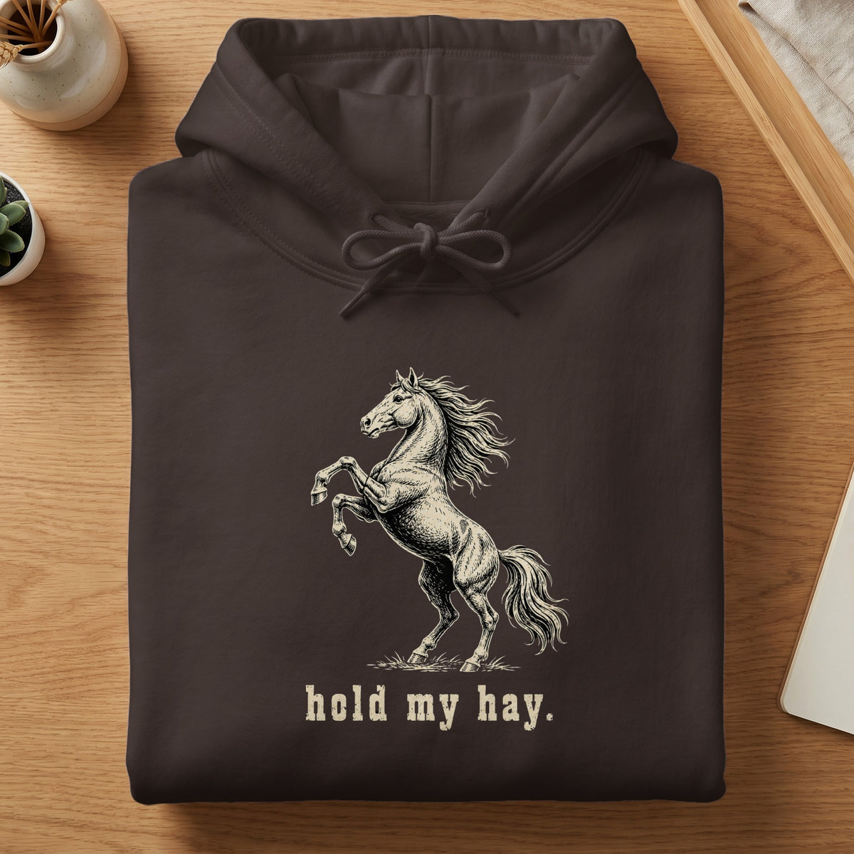 Brown hoodie with a rearing horse graphic and text "hold my hay."
