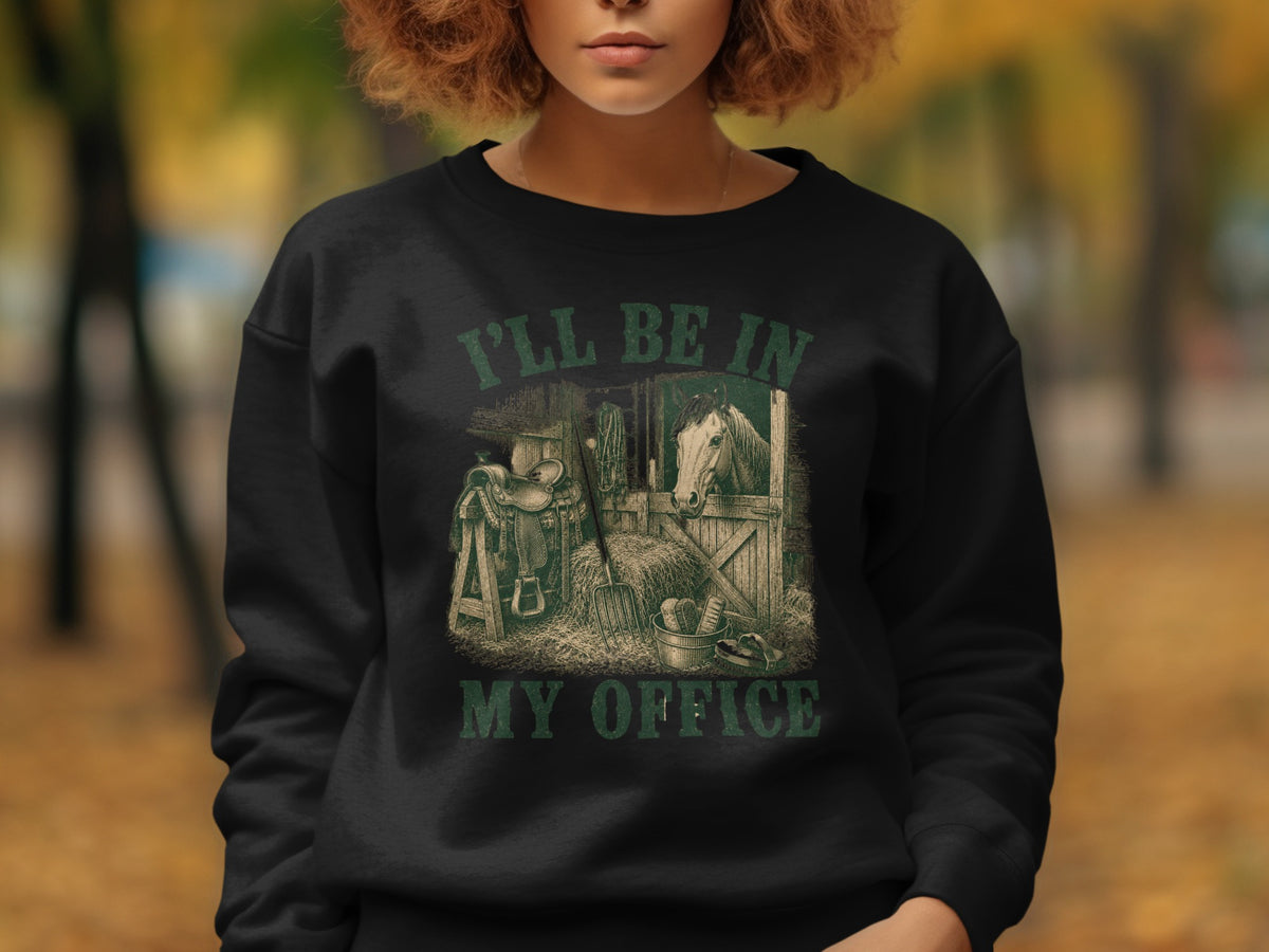 Black sweatshirt with barn, horse, saddle, and text "I'LL BE IN MY OFFICE."